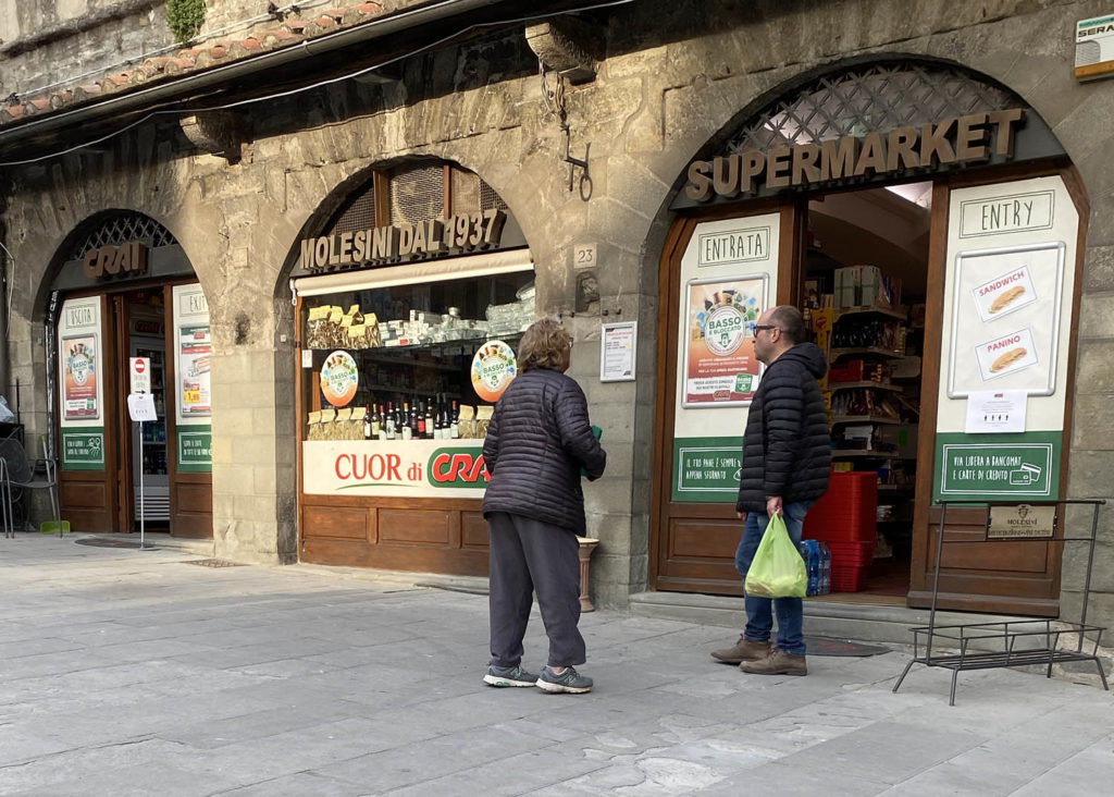 The "Line" forms outside of Molesini Market in Cortona.